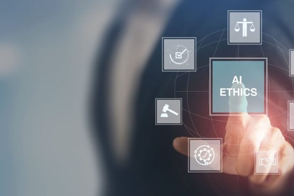 person pointing to transparent screen with icons and one stating AI Ethics