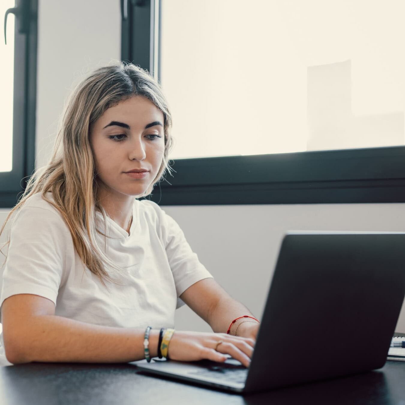 Woman takes her ICF Credential exam remotely.