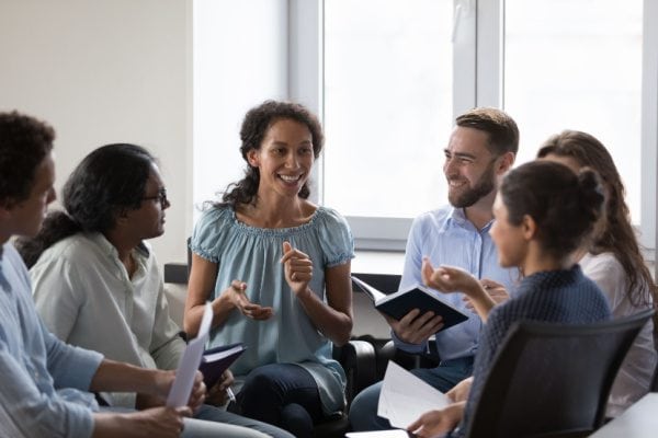coach speaking to a professional group in a group coaching session