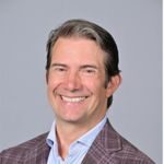 Headshot of Woody Woodward, PCC with the International Coaching Federation. Known for co-founding and leading NYU's Master of Science in Executive Coaching and Organizational Consulting (ECOC) program and expertise in organizational consulting at PricewaterhouseCoopers Consulting (PwC) and project management for IBM Business Consulting Services.