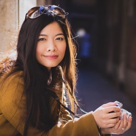 Headshot of a woman holding a camera